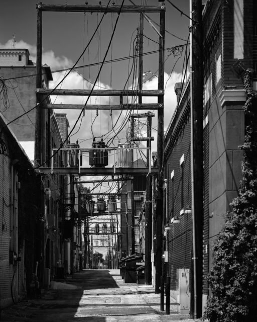This one probably won’t get many likes. There’s no colorful flowers, no pretty view. It’s gritty and raw. It’s an alleyway with wires and electrical poles.  But it’s also art. It’s light and shadows. It’s lines and texture.